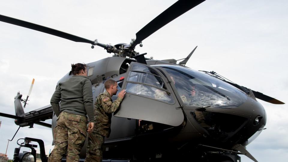 Spc. Aurora Cannon and Staff Sgt. Kaleb Smart discuss maintenance support for an LUH-72 Lakota helicopter on May 25, 2017. (Spc. Elizabeth Scott/U.S. National Guard)