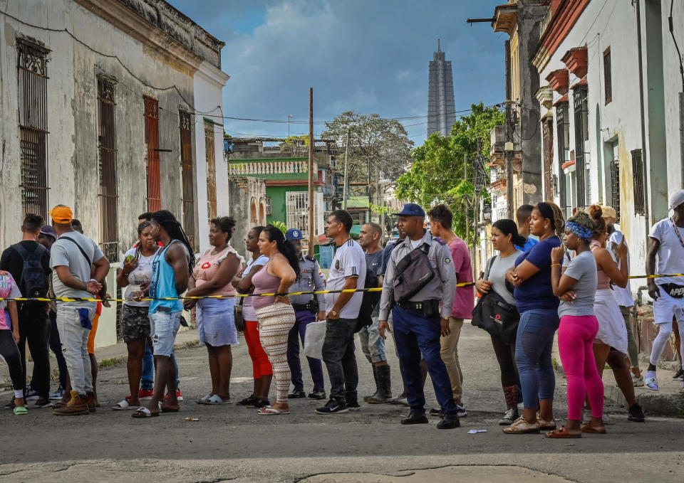 A crowd watches as power lines are repaired after several days without electricity in El Cerro, Cuba. (Adalberto Roque  / AFP - Getty Images)