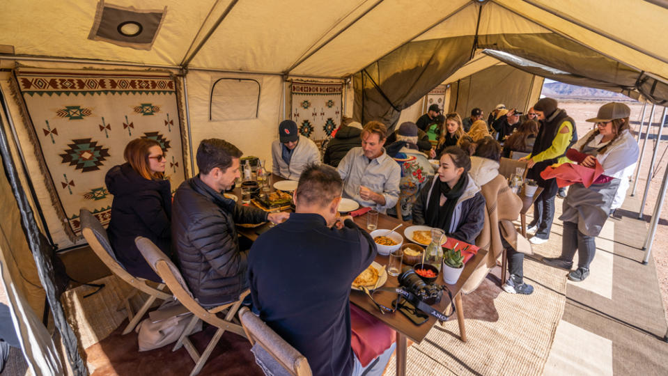 Participants in O'Gara's Desert Escape driving experience enjoy a catered meal comprising locally sourced cuisine that's served in a chic, camp-like setting. 