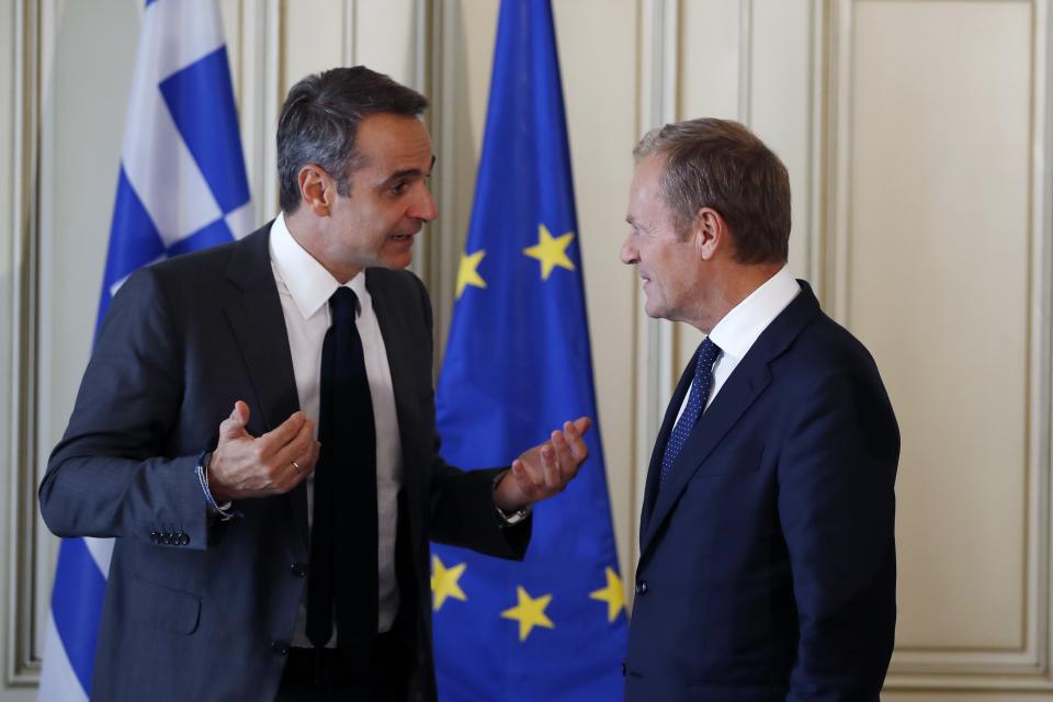 Greece's Prime Minister Kyriakos Mitsotakis, left, speaks with the European Council President Donald Tusk during their meeting at Maximos Mansion in Athens, Wednesday, Oct. 9, 2019. EU leaders have demanded more "realism" from Britain in response to a Brexit plan proposed by British Prime Minister Boris Johnson. (AP Photo/Thanassis Stavrakis)