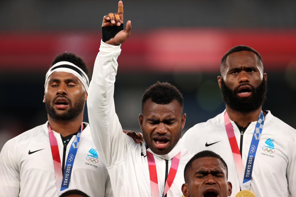 Fiji rugby player Jerry Tuwai of Team Fiji sings on the podium