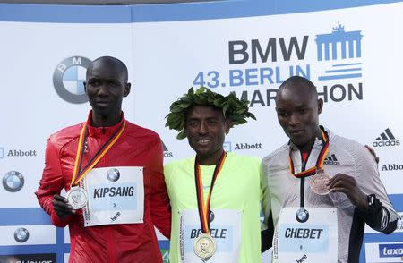 Second placed Wilson Kipsang (L to R) of Kenia, winner Kenenisa Bekele of Ethiopia and third-placed Evans Chebet of Kenia pose with their medals during the victory ceremony at the Berlin marathon in Berlin, Germany, September 25, 2016. REUTERS/Fabrizio Bensch