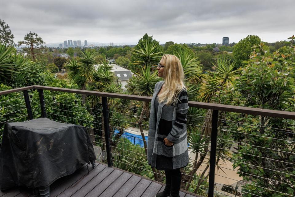 Jennifer Bedolla stands on a top tier patio in her backyard, that has been inundated with very brazen coyotes in Mar Vista.
