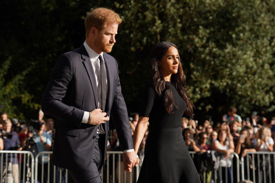 FILE _ Meghan, Duchess of Sussex and Prince Harry meet members of the public at Windsor Castle, following the death of Queen Elizabeth II on Thursday, in Windsor, England, Saturday, Sept. 10, 2022. Prince Harry and his wife, Meghan, are expected to vent their grievances against the monarchy when Netflix releases the final episodes of a series about the couple’s decision to step away from royal duties and make a new start in America. (Kirsty O'Connor/Pool Photo via AP, File)