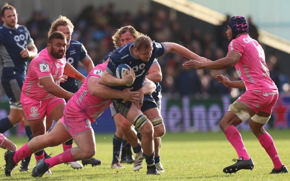 Ben Bamber of Sale Sharks is tackled by Juan Johan Van der Mescht of Stade Francais Paris during the Investec Champions Cup match between Sale Sharks and Stade Francais Paris at AJ Bell Stadium on December 10, 2023 in Salford, England
