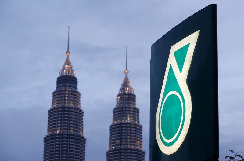 FILE PHOTO: The logo of a Petronas fuel station is seen with the Petronas Twin Towers in the background in Kuala Lumpur