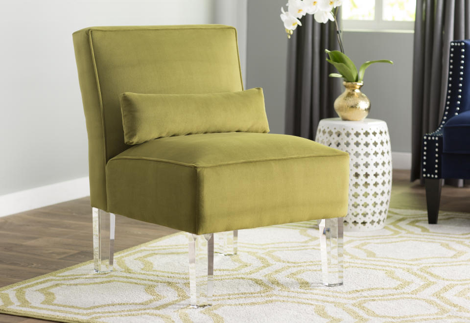 This undated image provided by Wayfair shows the Ralston Slipper Chair by Wayfair's exclusive brand Mercer41. The chair features acrylic legs. (Wayfair via AP)