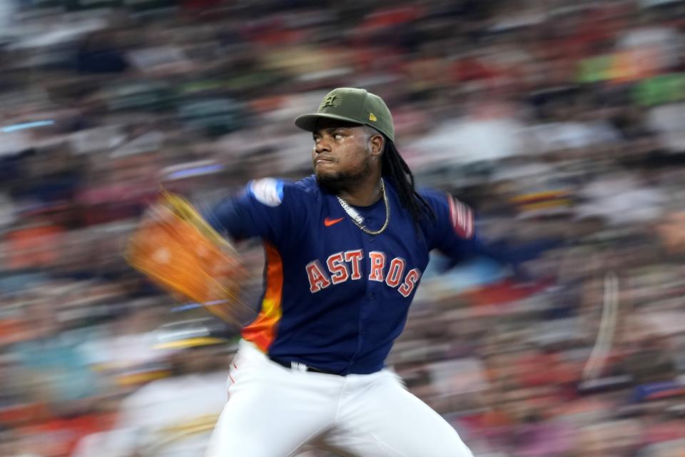 In this image taken with a slow shutter speed, Houston Astros' Framber Valdez throws against the Oakland Athletics during the fifth inning of a baseball game Sunday, May 21, 2023, in Houston. (AP Photo/David J. Phillip)