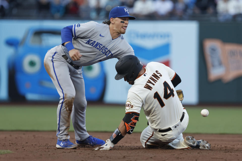 Kansas City Royals shortstop Bobby Witt Jr., top, reaches for the ball as San Francisco Giants' Austin Wynns (14) slides into second base in the third inning a baseball game in San Francisco, Monday, June 13, 2022. (AP Photo/Josie Lepe)
