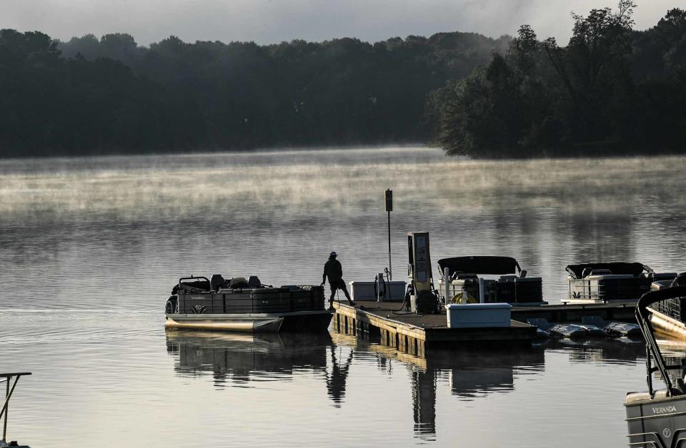 A man docks a pontoon at Clemson Marina in Seneca, with fog lifting off of Lake Hartwell Monday, September  27. 