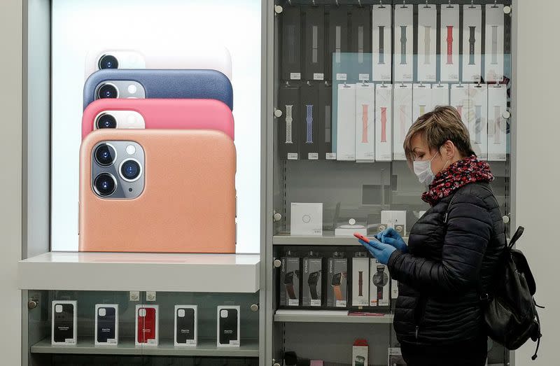 A customer wearing a protective mask and gloves walks in an Apple reseller shop reopened following loosened lockdown restrictions amid the coronavirus disease (COVID-19) outbreak in Kaliningrad