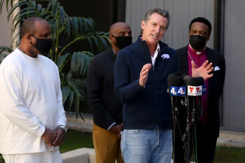 INGLEWOOD, CA - FEBRUARY 21: Governor Gavin Newsom, shown with Inglewood Mayor James T. Butts Jr., left, Steven Bradford (D-Gardena) and Rev. Kenneth Ulmer, addresses the media while visiting a mobile COVID-19 vaccination site to discuss the state's efforts to vaccinate hard-to-reach and disproportionately impacted communities at Faithful Central Bible Church on Sunday, Feb. 21, 2021 in Inglewood, CA. State and local agencies vaccinated 250 people from the community on Sunday. (Gary Coronado / Los Angeles Times)