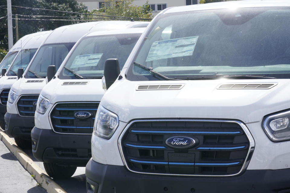 File - Ford E-Transit electric vans are displayed at a Gus Machado Ford dealership Monday, Jan. 23, 2023, in Hialeah, Fla. The U.S. Postal Service is buying 9,250 of the E-Transit vans. (AP Photo/Marta Lavandier, File)