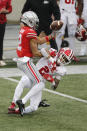 Ohio State receiver Chris Olave, left, bobbles the ball as Indiana defensive back Reese Taylor defends during the first half of an NCAA college football game Saturday, Nov. 21, 2020, in Columbus, Ohio. (AP Photo/Jay LaPrete)