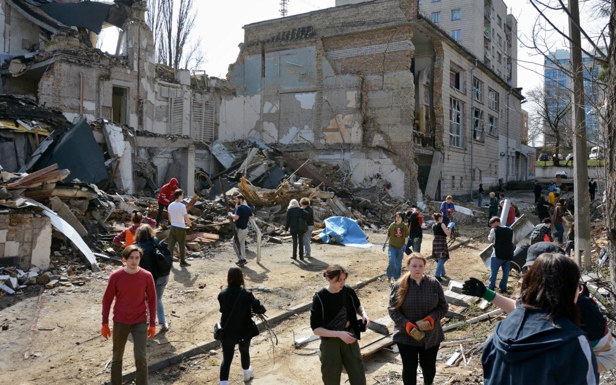 Volunteers and students of the Kyiv State Academy of Decorative and Applied Arts and Design gather to clean up the debris at the art academy building, destroyed as result of Russian missile attack, on March 30, 2024 in Kyiv, Ukraine.