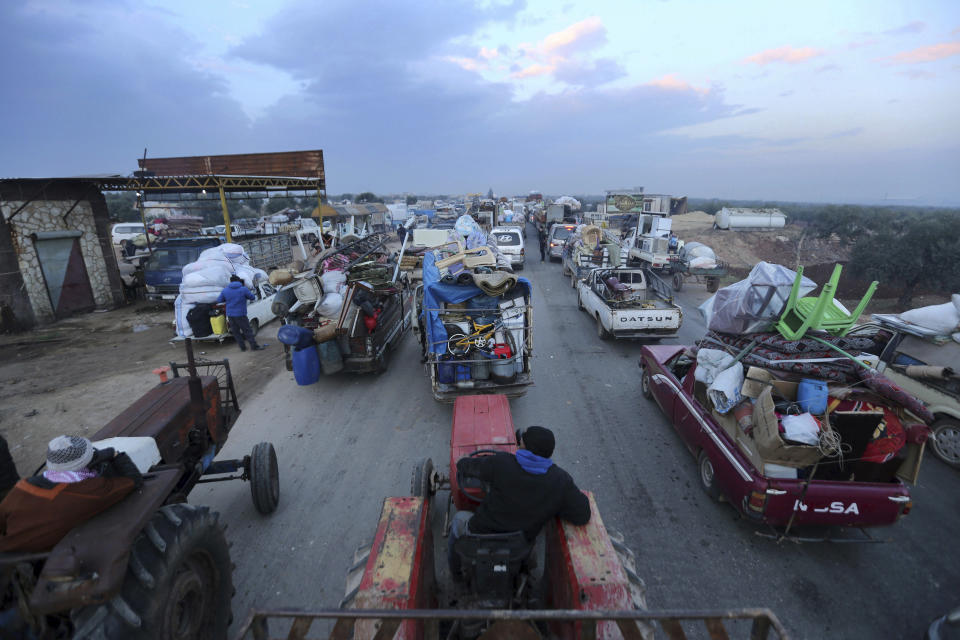 Truckloads of civilians flee a Syrian military offensive in Idlib province on the main road near Hazano, Syria, Tuesday, Dec. 24, 2019. Syrian forces launched a wide ground offensive last week into the northwestern province of Idlib, which is dominated by al-Qaida-linked militants. The United Nations estimates that some 60,000 people have fled from the area, heading south, after the bombings intensified earlier this month. (AP Photo/Ghaith al-Sayed)