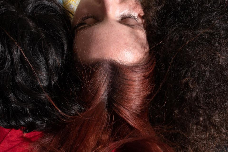 Three heads of hair lying together