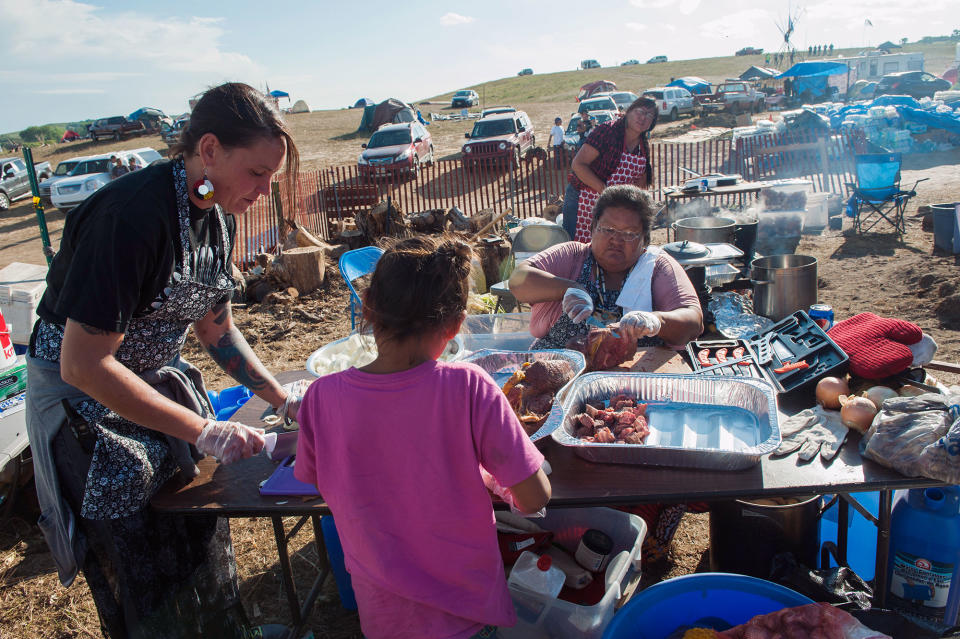 <p>Vandee Khalsa, left, Tatanka Skawin SwiftBird, center, and Winona Kasto prepare buffalo soup for protesters gathered to stop construction of the Dakota Access oil pipeline near the Standing Rock Sioux reservation in Cannon Ball, N.D., on Sept. 6, 2016. (Photo: Andrew Cullen/Reuters) </p>