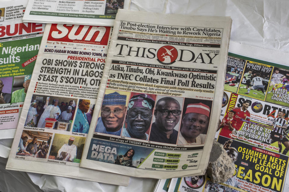 Newspapers are displayed at a street vendor at an intersection in Lagos, Nigeria on Sunday, Feb. 26, 2023. Nigerians voted Saturday to choose a new president, following the second and final term of incumbent Muhammadu Buhari. (AP Photo/Ben Curtis)