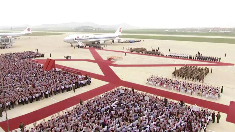 In this image made from video, North Korean people and a guard of honor welcome a plane with Chinese President Xi Jinping onboard, on the arrival at an airport in Pyongyang, Thursday, June 20, 2019. The leaders of China and North Korea were talking in the North Korean capital Thursday, with stalled nuclear negotiations with Washington expected to be on the agenda. (CCTV via AP)