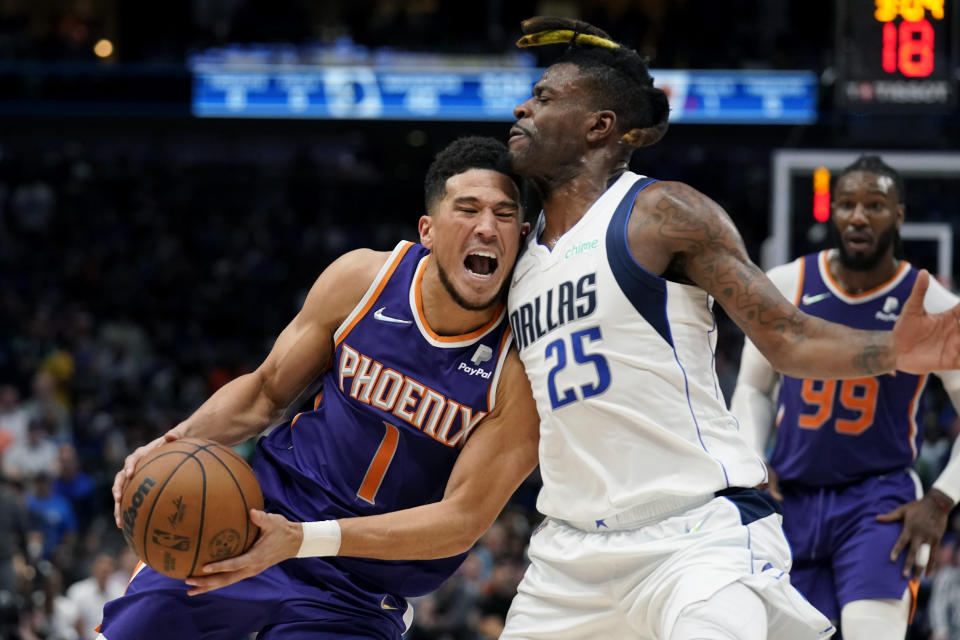 Phoenix Suns guard Devin Booker (1) drives to the basket against Dallas Mavericks forward Reggie Bullock (25) during the first half of Game 3 of an NBA basketball second-round playoff series, Friday, May 6, 2022, in Dallas. (AP Photo/Tony Gutierrez)