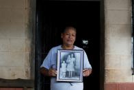 Miriam Marquez holds a picture of her mother in law killed by Salvadorean soldiers in the village of El Mozote, in the town of Meanguera