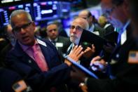 Traders work on the floor at the New York Stock Exchange (NYSE) in New York