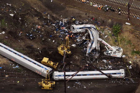 Emergency workers look through the remains of a derailed Amtrak train in Philadelphia, Pennsylvania May 13, 2015. REUTERS/Lucas Jackson