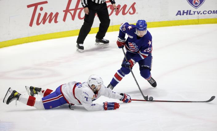 Amerks Artuu Ruotsalainen tries to stick handle the puck past Laval's Louie Belpedio.