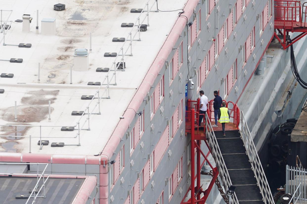 People boarding the Bibby Stockholm accommodation barge at Portland Port in Dorset. The Home Office have said around 50 asylum seekers would board the ship, with the numbers rising to its maximum capacity over the coming months, despite safety concerns raised by some of the county's Conservative MPs and locals. Picture date: Monday August 7, 2023.