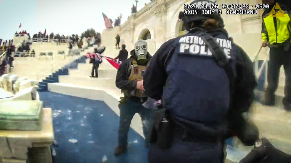 A man in a gas mask faces off with police on Jan. 6 2021 at the U.S. Capitol. (U.S. District Court for the District of Columbia)