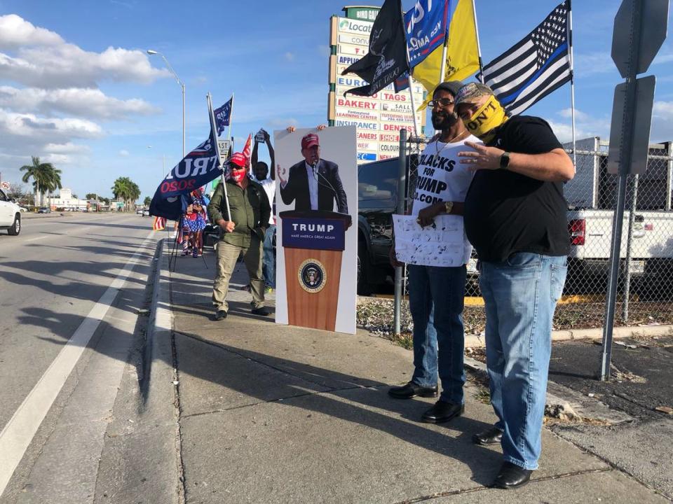 Ozzy Perez, foreground, poses at the front of a pro-Trump rally on Bird Road on Saturday, Jan. 16, 2021. The man to his right, in a Blacks for Trump T-shirt, declined to give his name.