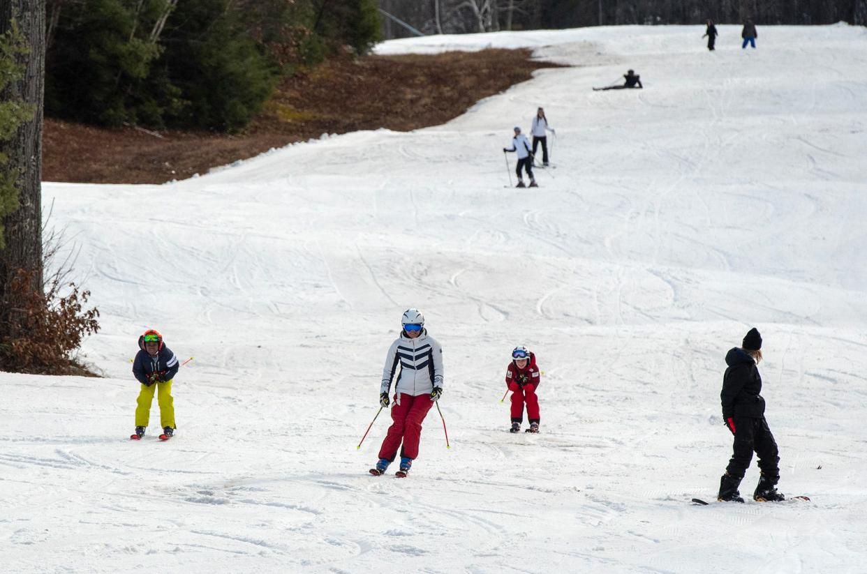 Skiers and riders make their way down the Indian Summer trail at Wachusett Mountain Tuesday.