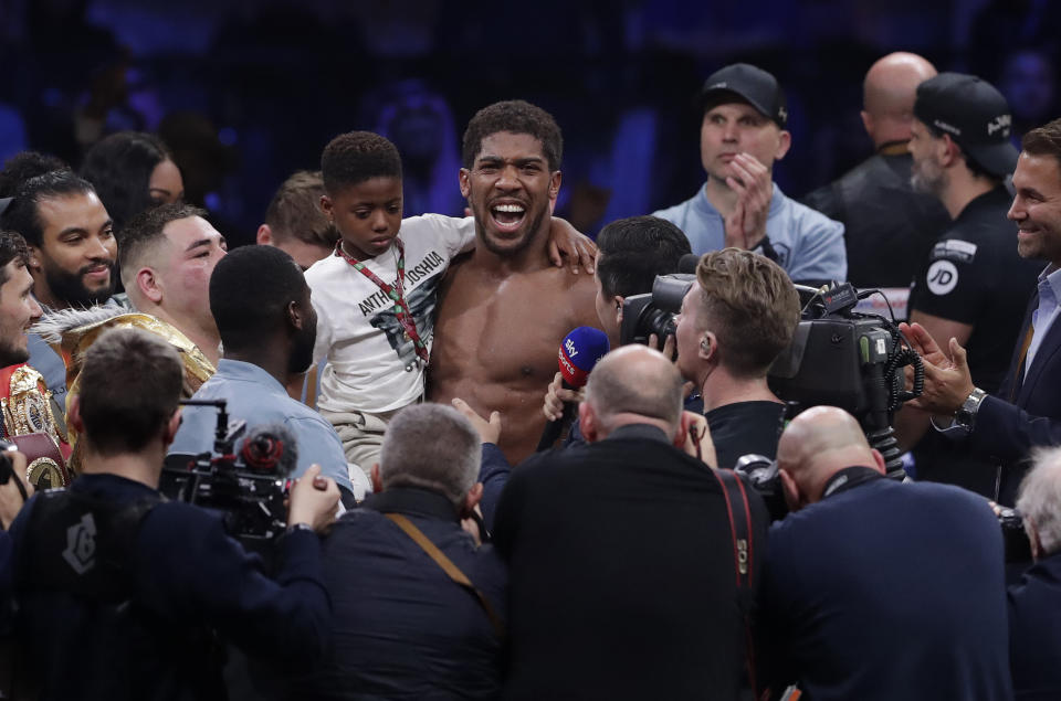 Britain's Anthony Joshua celebrates after beating Andy Ruiz Jr. to win their World Heavyweight Championship contest at the Diriyah Arena, Riyadh, Saudi Arabia early Sunday Dec. 8, 2019. (AP Photo/Hassan Ammar)