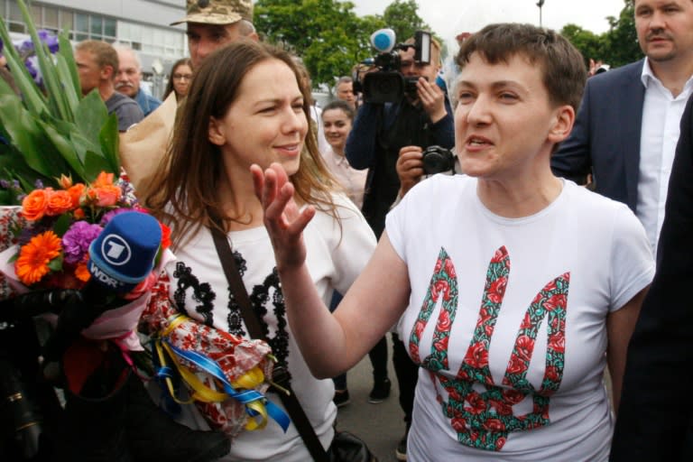 Nadiya Savchenko (R) arrived in Kiev to a hero's welcome after nearly two years in a Russian prison