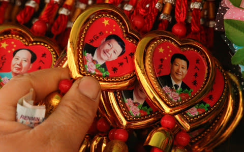 Xi Jinping and Mao Tse-tung necklaces - Credit: Reuters