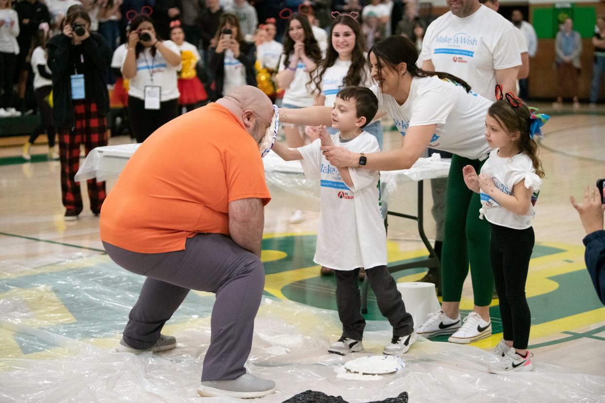 Cash Blanchfield smashes a pie in the face of Ken Osborne during the "Wish Week" assembly. The assembly culminated the week where students and staff raised money for the Make-a-Wish Foundation on Wednesday, March 15, 2023.