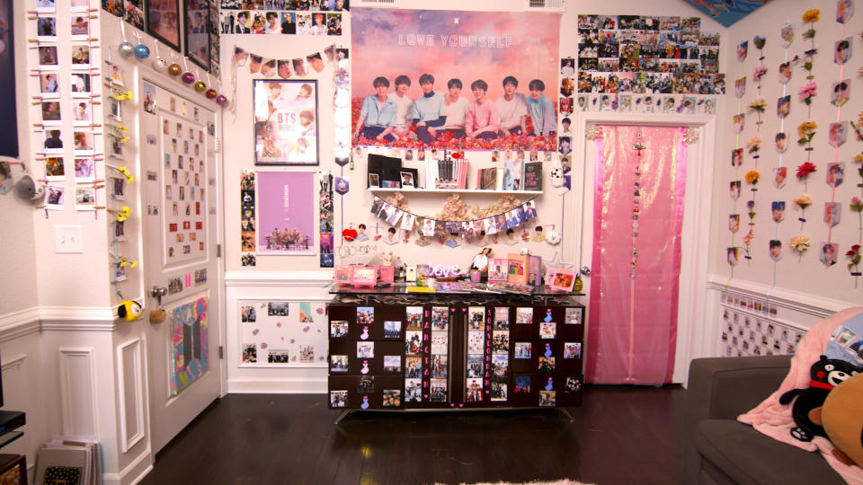 The BTS HQ room consists of hundreds of BTS photos, albums, merch, plushies, and more. 