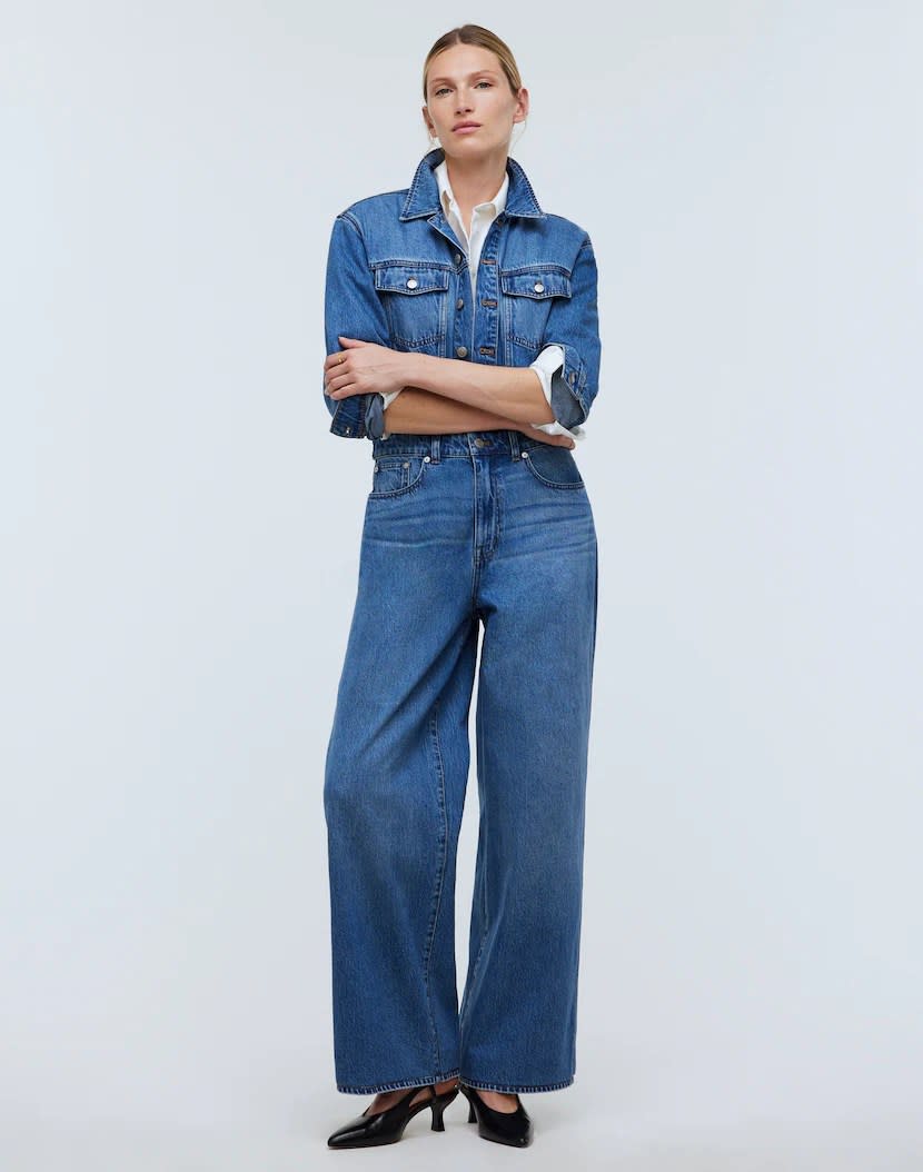 model wearing medium wash denim jumpsuit coverall