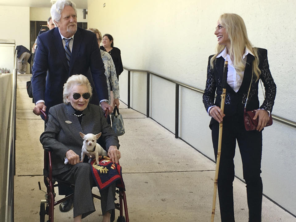 FILE - In this March 15, 2018 file photo, Abigail Kawananakoa, a 91-year-old Hawaiian heiress, is wheeled from a Honolulu courtroom. Board members of a foundation a 92-year-old heiress established for Native Hawaiians are calling for a judge to protect her $215 million trust. Many Native Hawaiians consider Abigail Kawananakoa to be the last Hawaiian princess because of her lineage. Her wealth is embroiled in a legal fight and a key court hearing is scheduled for Monday, Sept. 10, 2018. (AP Photo/Jennifer Sinco Kelleher, File)
