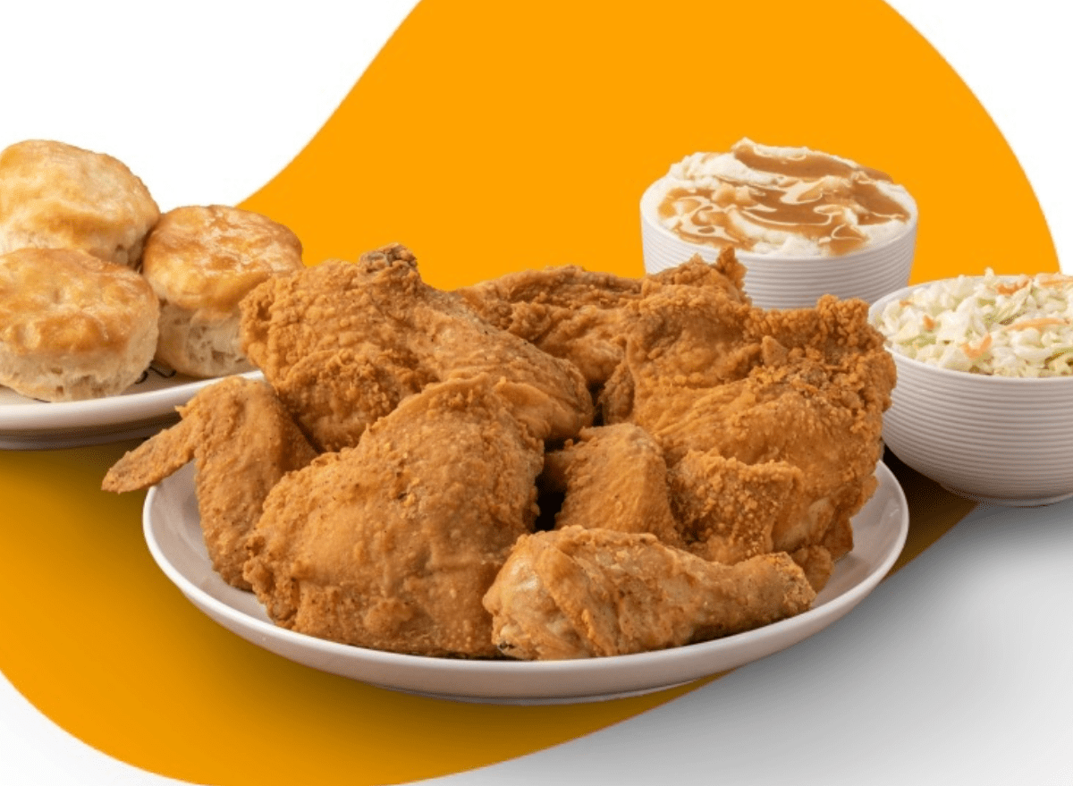 lees fried chicken on a plate with mashed potatoes and biscuits.