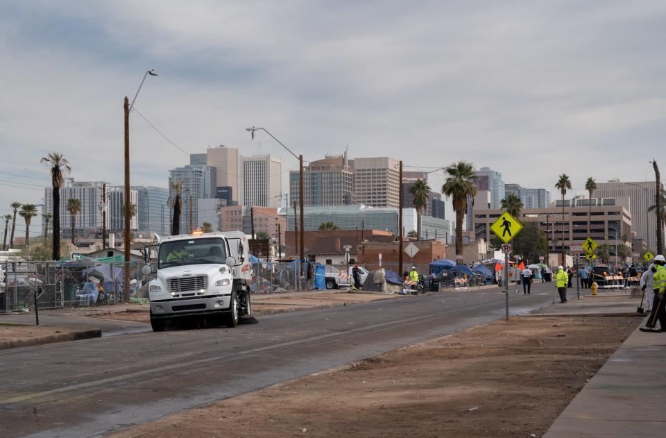 Madison Street is cleaned by a street sweeper between 12th and 13th avenues on Dec. 16, 2022, during Phoenix's enhanced cleanup of the area.