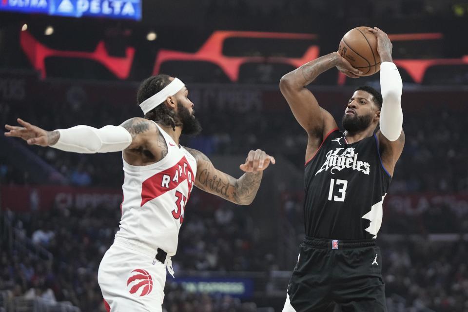 Los Angeles Clippers forward Paul George, right, shoots as Toronto Raptors guard Gary Trent Jr. defends during the first half of an NBA basketball game Wednesday, Jan. 10, 2024, in Los Angeles. (AP Photo/Mark J. Terrill)