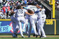 Seattle Mariners players celebrate with a group dance in center field after defeating the Los Angeles Angels in the first game of a baseball doubleheader, Saturday, Aug. 6, 2022, in Seattle. (AP Photo/Caean Couto)