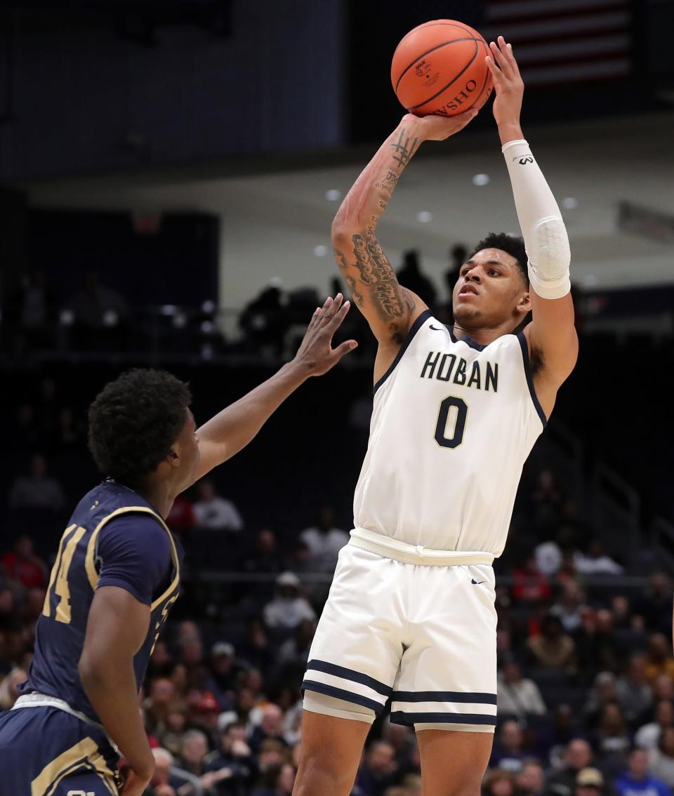 Hoban guard Jonas Nichols, right, attempts a shot over St. John's Jesuit's Joseph Taylor during a Division I state semifinal March 18 in Dayton.