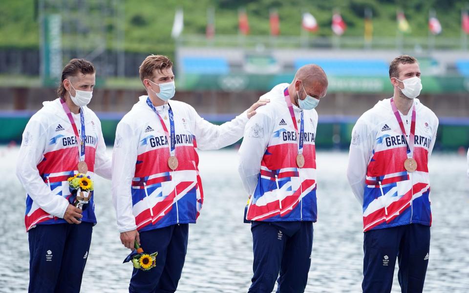 Josh Bugajski and the rest of the crew on the podium after winning bronze - PA