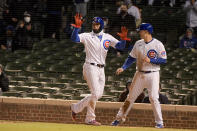 Chicago Cubs' shortstop Javier Baez (9) and first baseman Anthony Rizzo (44) celebrate scoring against the New York Mets during the fourth inning of a baseball game Wednesday, April 21, 2021, in Chicago. (AP Photo/Mark Black)