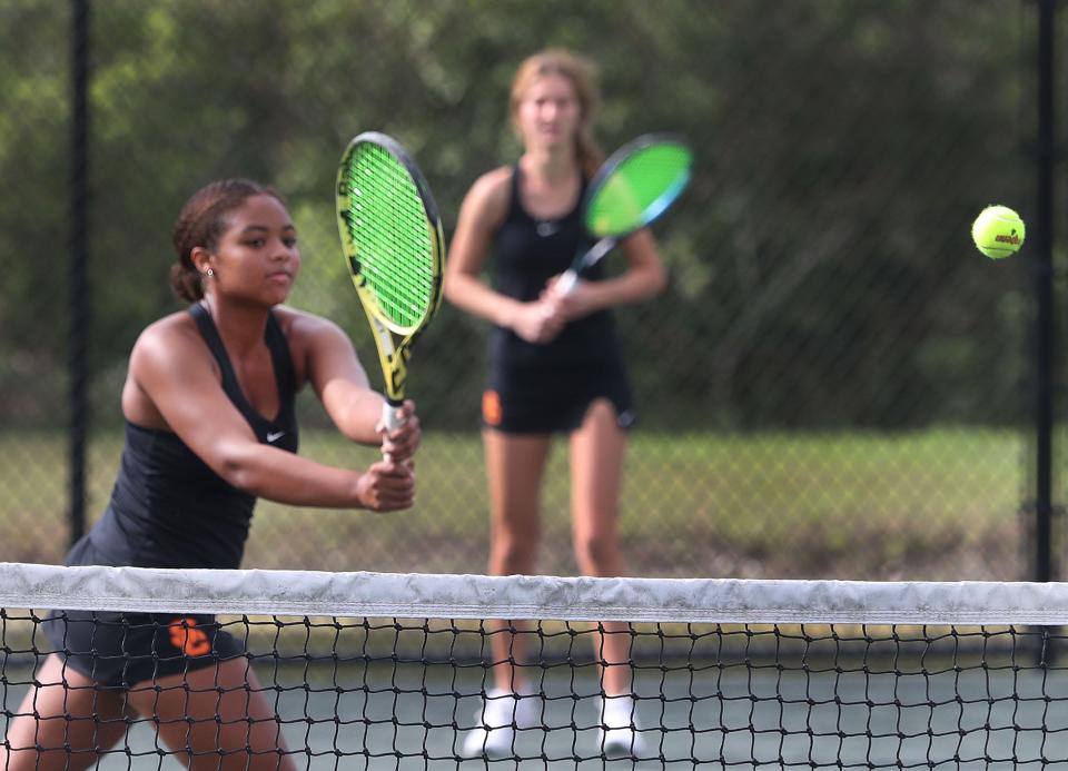 Spruce Creek High's Gisselle Adekunle returns a shot in doubles action, Friday March 8, 2024 in Five Star Conference Tennis Championships.
