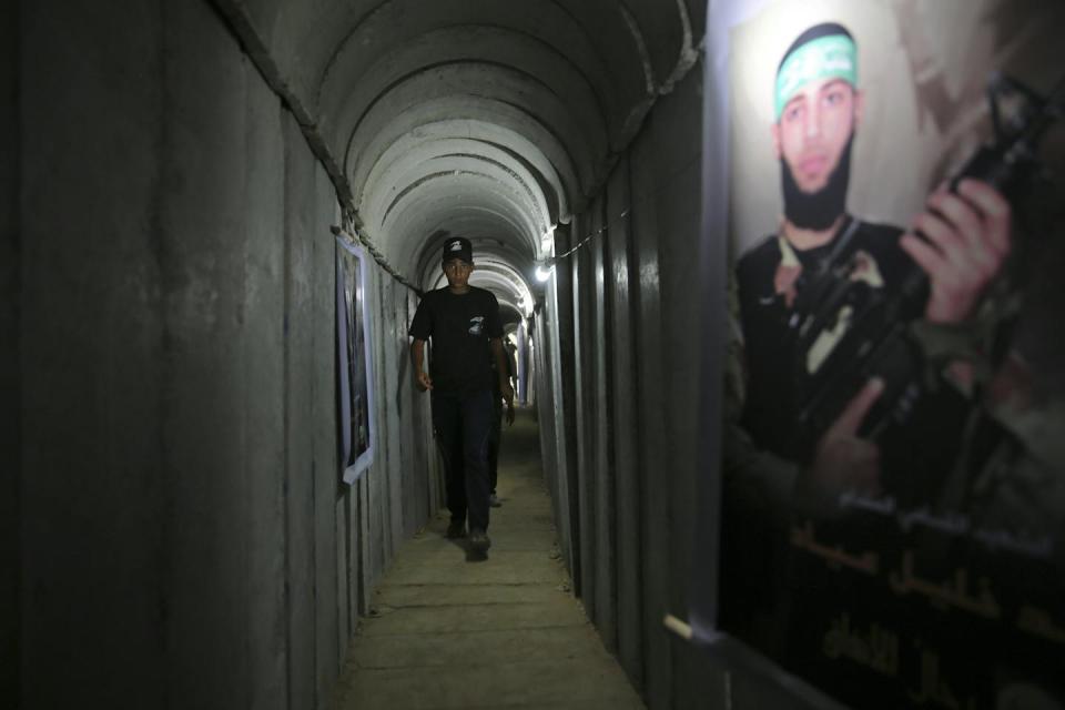 A Palestinian youth walks inside a tunnel used for military exercises during a weapons exhibition at a Hamas-run youth summer camp in Gaza City on July 20, 2016. <a href="https://newsroom.ap.org/detail/IsraelPalestiniansHamasTunnels/430337b57c1a463e889d815a407cb595/photo" rel="nofollow noopener" target="_blank" data-ylk="slk:AP Photo/Adel Hana;elm:context_link;itc:0;sec:content-canvas" class="link ">AP Photo/Adel Hana</a>