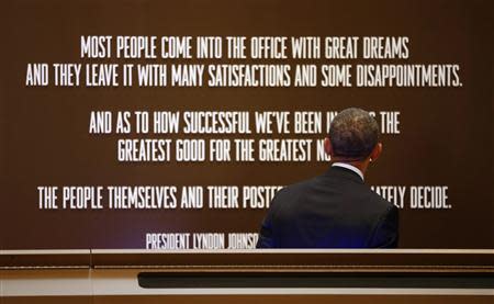U.S. President Barack Obama looks at a quote as he tours the LBJ Presidential Library before speaking at a Civil Rights Summit to commemorate the 50th anniversary of the signing of the Civil Rights Act in Austin Texas April 10, 2014. REUTERS/Kevin Lamarque